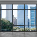 A large window with a black frame shows a view of Chicago's downtown skyline and trees on a sunny day.